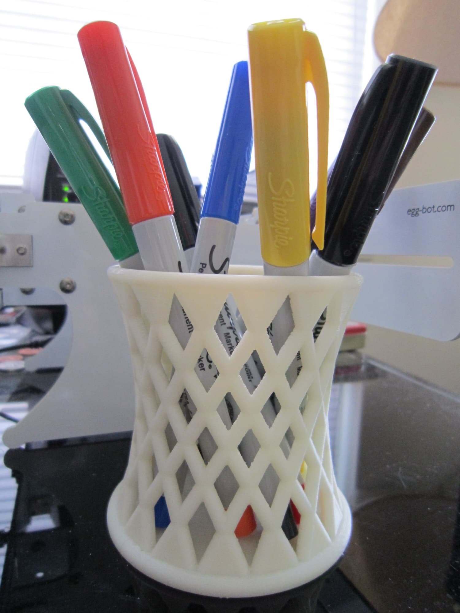 Hyperboloid 3D-printed pen holder on a desk